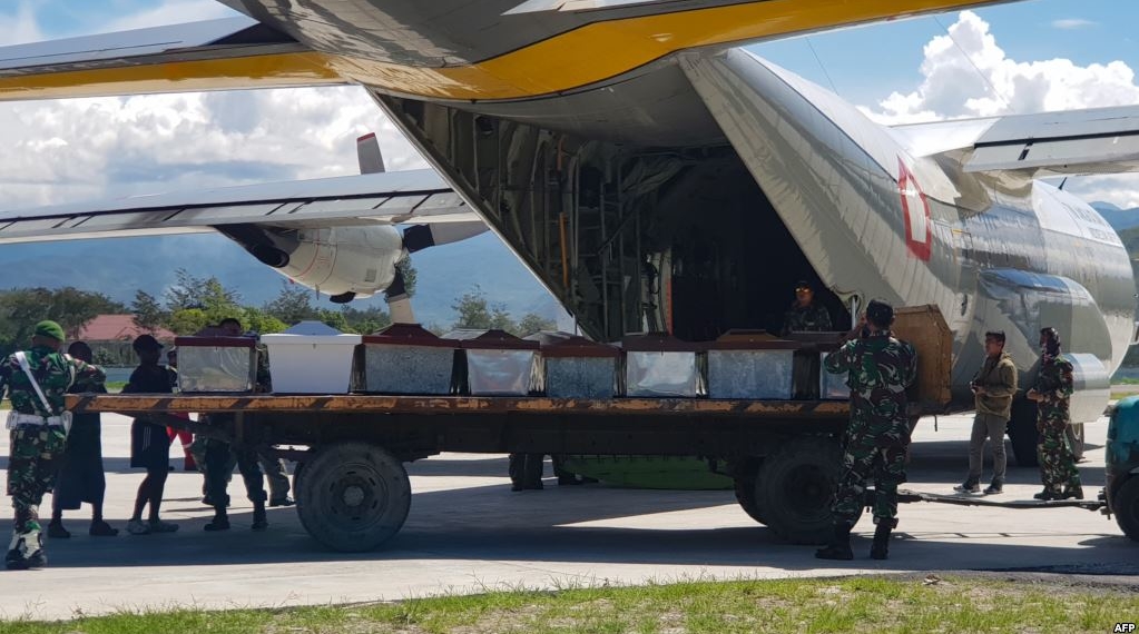 Anggota militer Indonesia menaikkan peti mati ke pesawat pengangkut di Wamena, provinsi Papua, 6 Desember 2018 (foto: Staf STEEL/AFP)