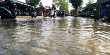 Genangan air di jalan Achmad Nadjamudin, Kota Gorontalo. Selain drainase yang buruk, sampah juga menyebabkan air sampai meluap ke jalan dan rumah warga. Foto: Lukman Polimengo.