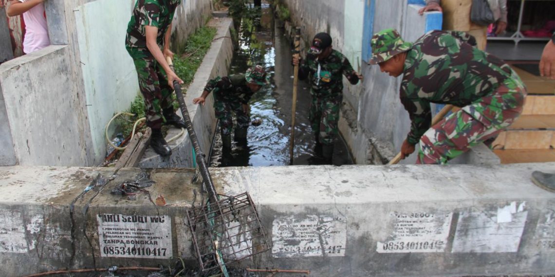 Koramil 1304-02/Kota Selatan melakukan aksi bersih-bersih, menyasar titik ke dua, dalam upaya mencegah banjir di lokasi drainase Pasar Central, Senin (13/1/2020).