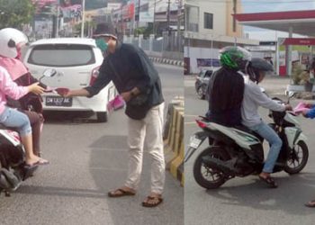 Pengurus wilayah PMII Kota Gorontalo membagi-bagikan masker kepada warga yang melintas di Bundaran Saronde, Kota Gorontalo. Foto: Lukman Polimengo.