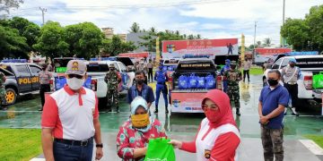 Kapolda Gorontalo, Irjen Pol. Adnas didampingi Ketua Bhayangkari Polda Gorontalo, saat memberikan bantuan paket Sembako kepada warga terdampak Covid-19.