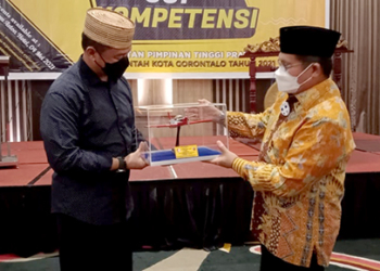 Komandan Pangkalan Udara (Lanud) “Tentara Langit” Sam Ratulangi, Marsekal Pertama TNI M. Satriyo Utomo (kopiah keranjang), menyerahkan cindera mata kepada Wali Kota Gorontalo, Marten Taha.