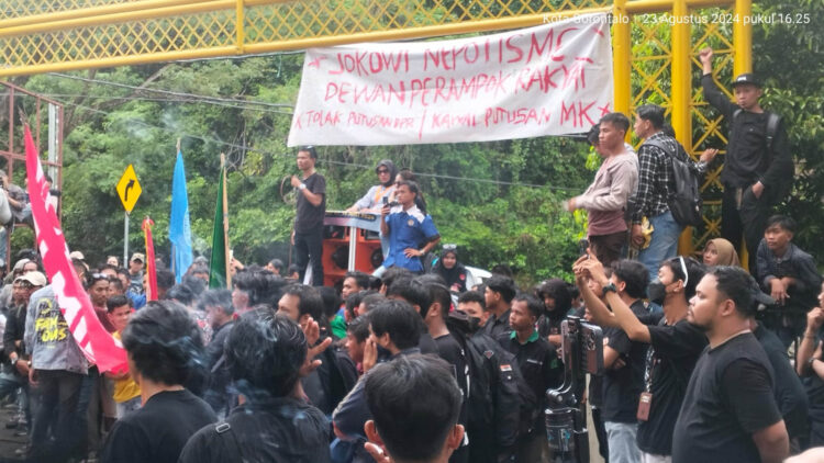 Mahasiswa yang melakukan demo di Kantor DPRD Provinsi Gorontalo memasang spanduk di pintu gerbang. Foto : Lukman Polimengo/mimoza.tv.