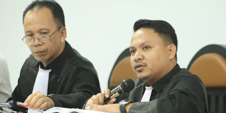 Donal Taliki, SH (pegang mic), bersama Trisno Kamba, SH, selakuaAnggota tim kuasa hukum Hamim Pou.