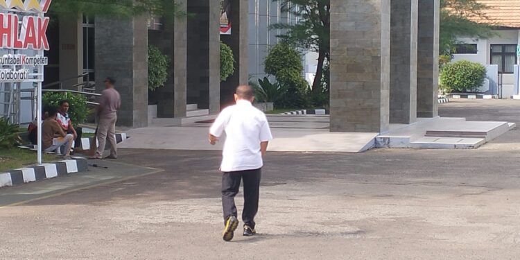 Ketua KONI Provinsi Gorontalo, Fikram Salilama, saat menuju ruang pemeriksaan intensif oleh penyidik Kejaksaan Tinggi (Kejati) Gorontalo, Jumat (10/4/2025). Foto Lukman.